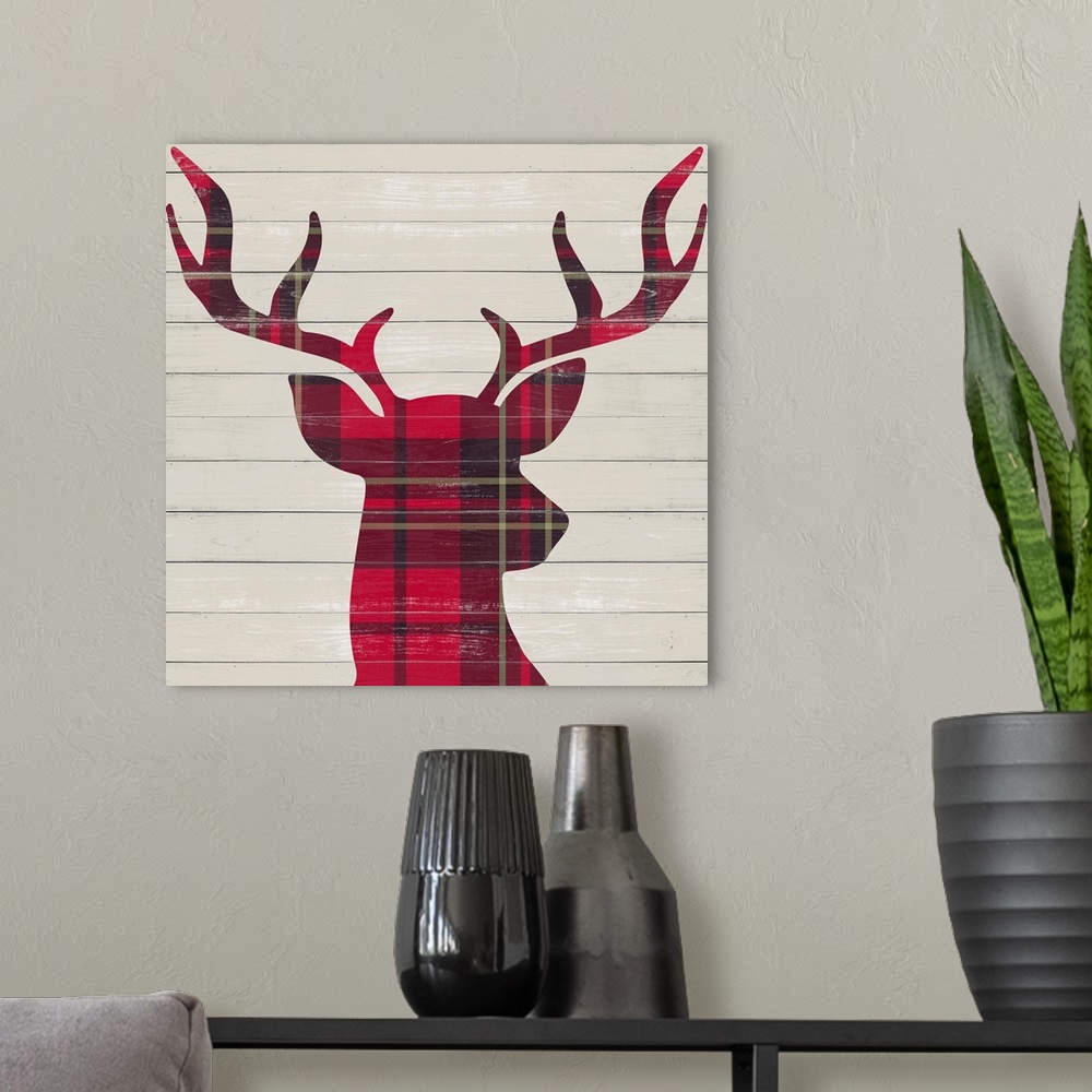 A modern room featuring A red plaid silhouette of a deer on a wood paneled background.