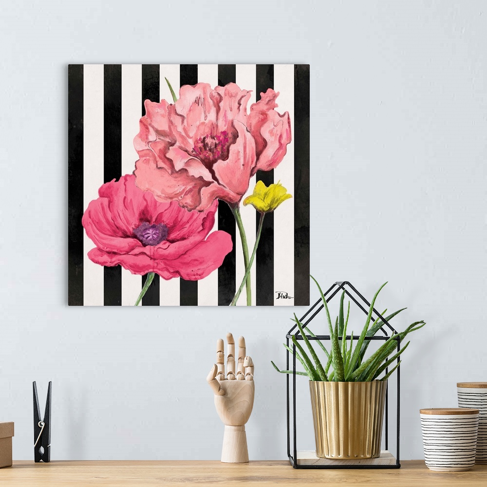 A bohemian room featuring A square painting of pink poppy flowers on a black and white vertically striped background.