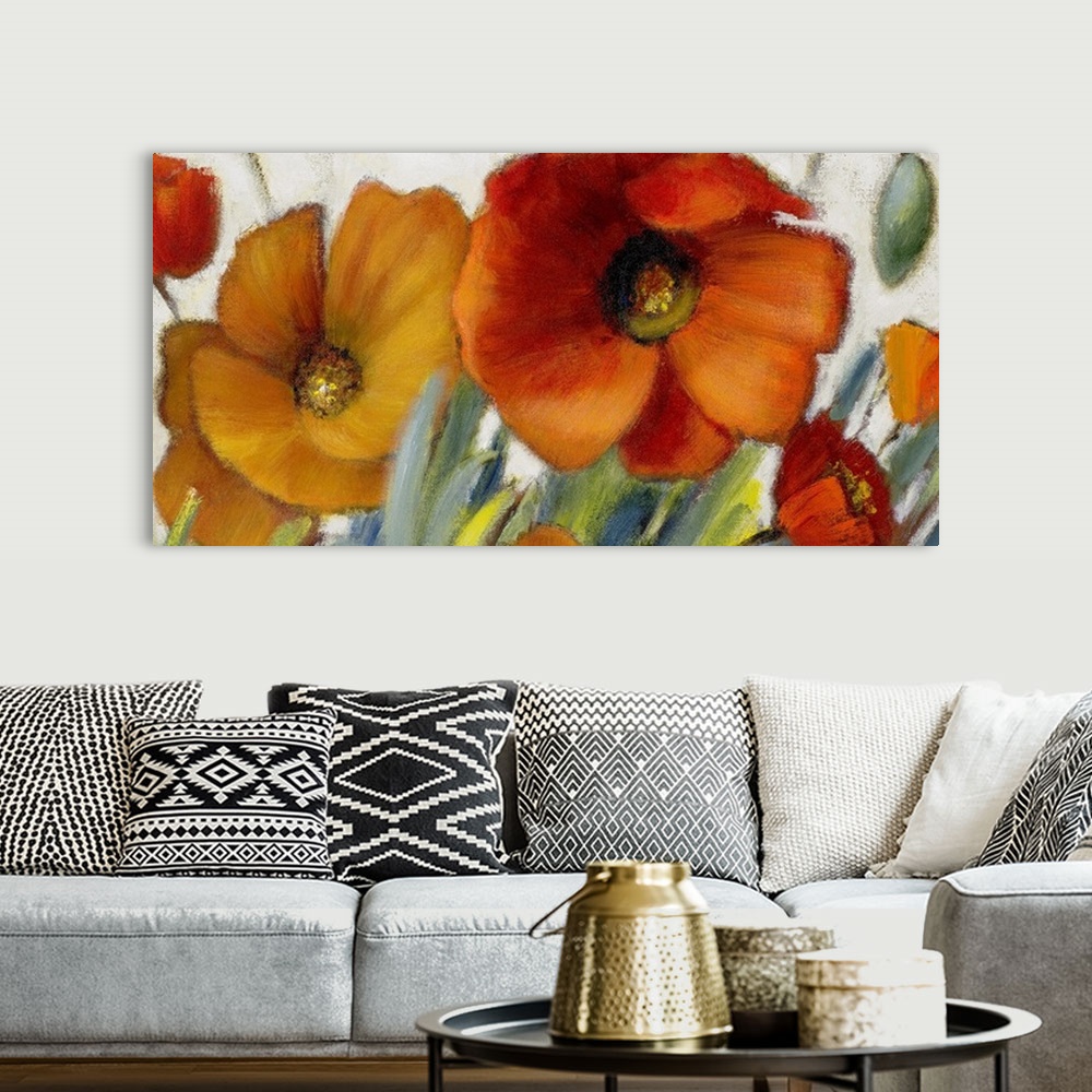 A bohemian room featuring Oversized, horizontal floral painting of two large poppies in warm tones, with several smaller po...