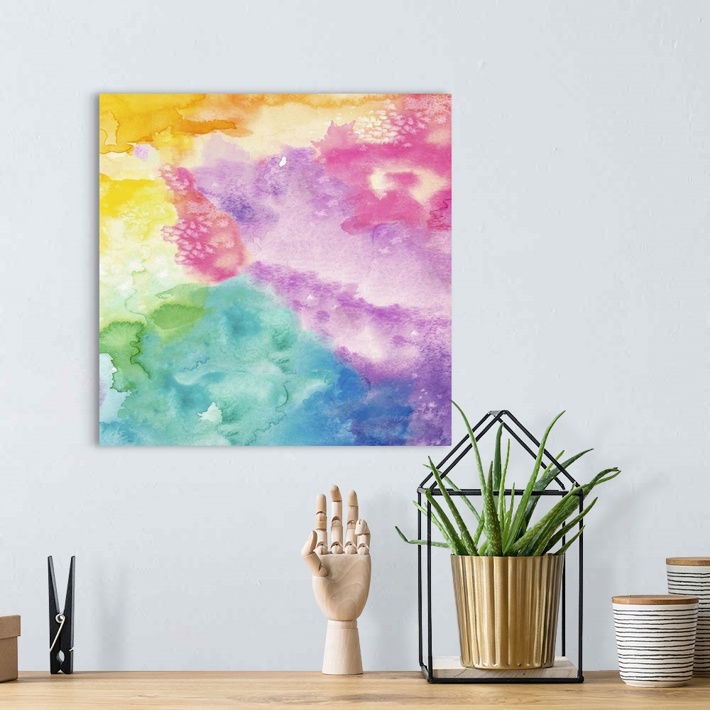 A bohemian room featuring Square abstract watercolor painting using all of the colors of the rainbow.