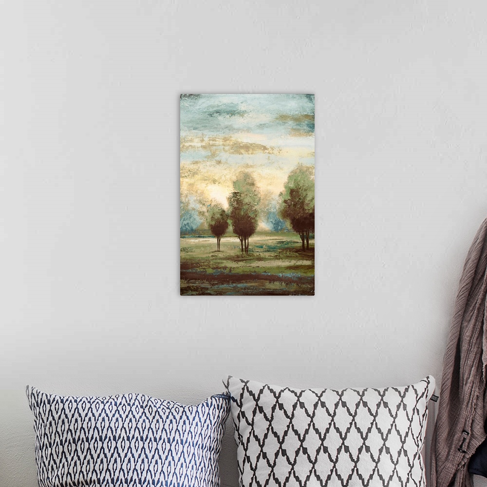 A bohemian room featuring A vertical landscape painting of trees under a misty sky, this painting is the second half of a d...
