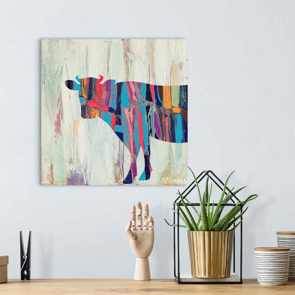 A bohemian room featuring Abstract painting of a cow silhouette with bright colors against a neutral background.