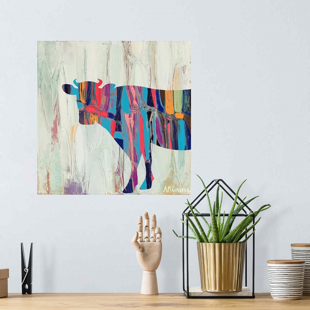 A bohemian room featuring Abstract painting of a cow silhouette with bright colors against a neutral background.