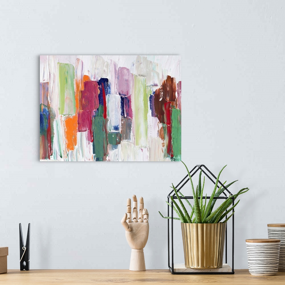 A bohemian room featuring Colorful abstract artwork in shades of green with bright orange.