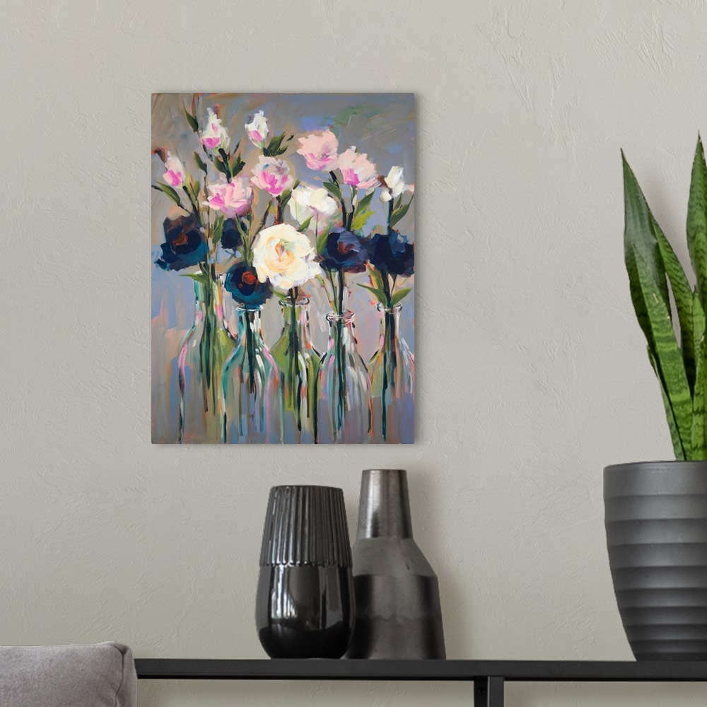 A modern room featuring Contemporary artwork of several flowers in a row of tall glass bottles.
