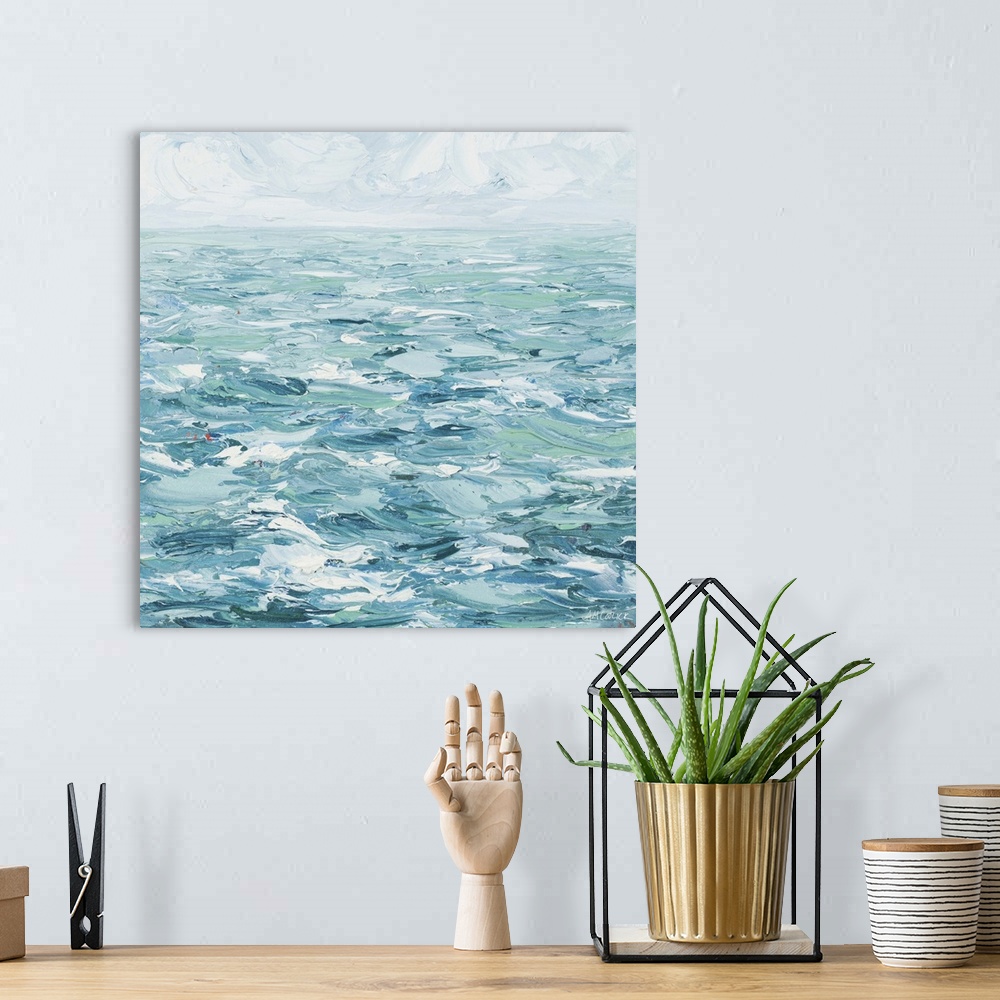 A bohemian room featuring Painting of ocean waves under a cloudy sky.
