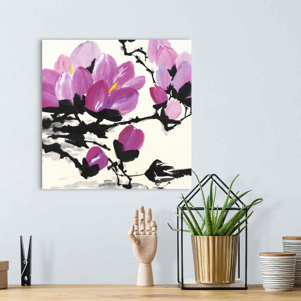 A bohemian room featuring A large artwork piece of cherry blossoms on black stems and branches.