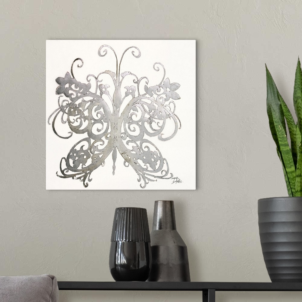 A modern room featuring A shiny silver designed butterfly on a solid white background.