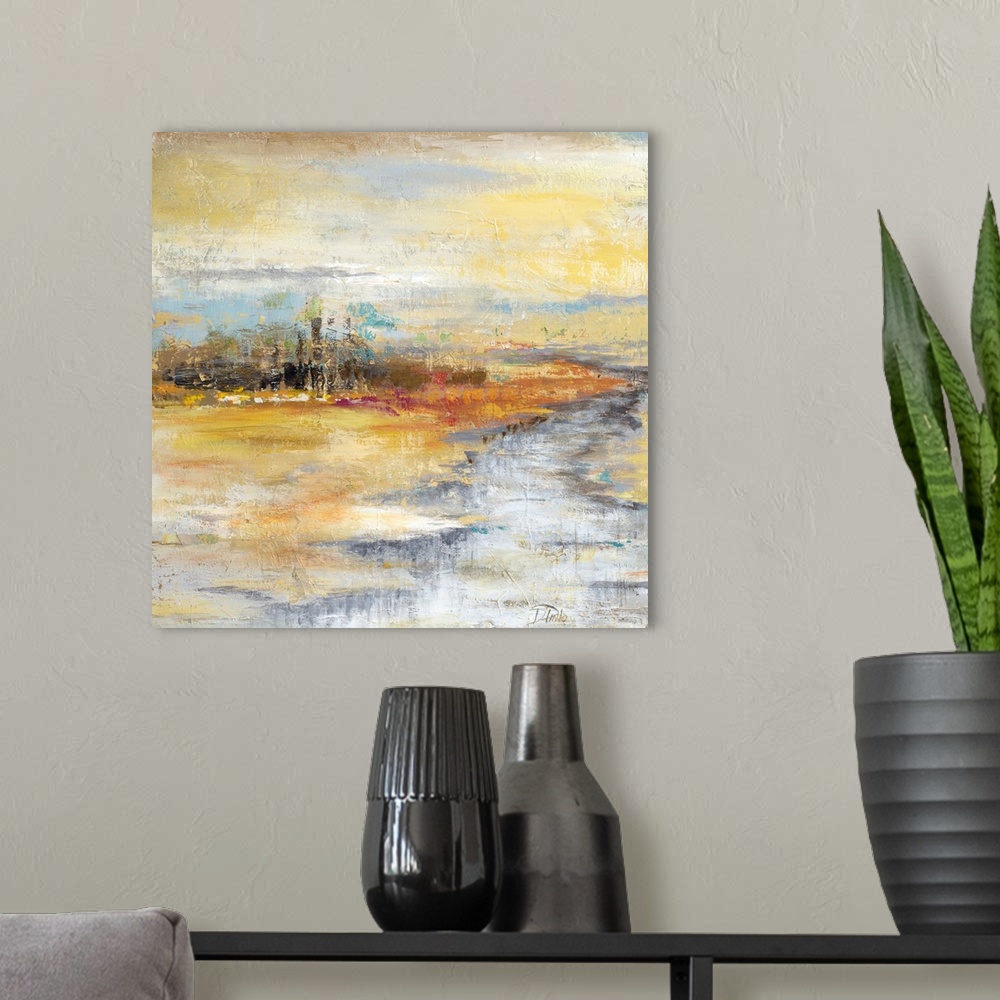 A modern room featuring Contemporary artwork of a river crossing through an orange landscape.