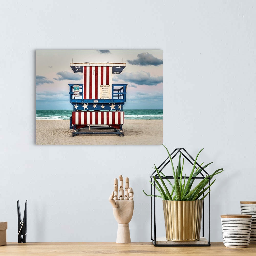 A bohemian room featuring Photograph of a lifeguard tower with an American flag design on the beach.