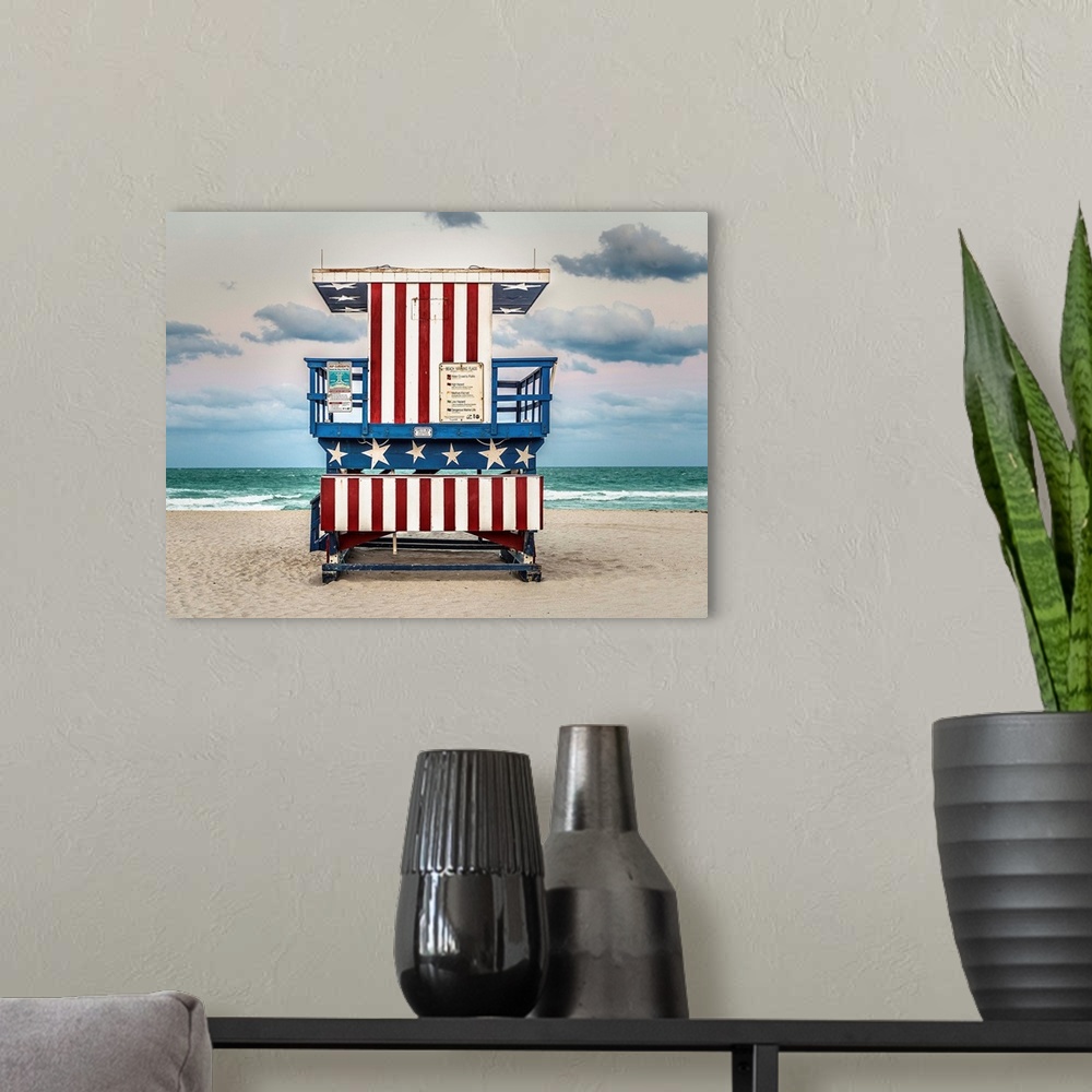 A modern room featuring Photograph of a lifeguard tower with an American flag design on the beach.