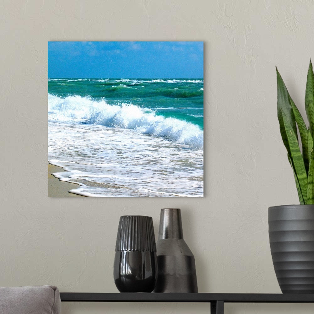 A modern room featuring Square canvas art of choppy crashing ocean waves.