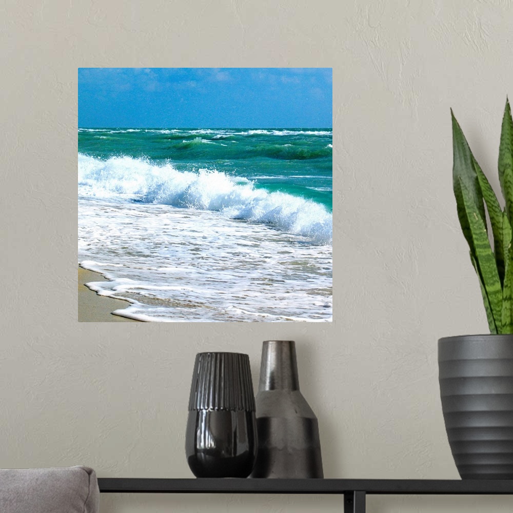 A modern room featuring Square canvas art of choppy crashing ocean waves.