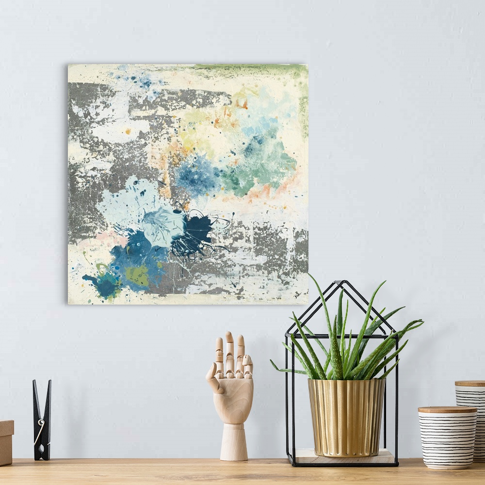 A bohemian room featuring Abstract artwork featuring an industrial ambience with blue and green paint splatters throughout.