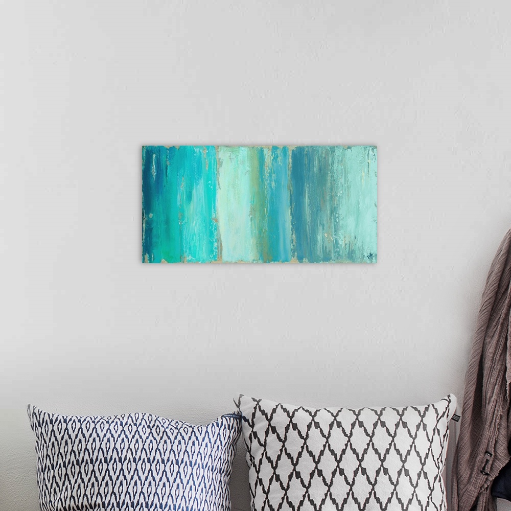 A bohemian room featuring A wide and skinny abstract painting with different shades of vertical blue lines.