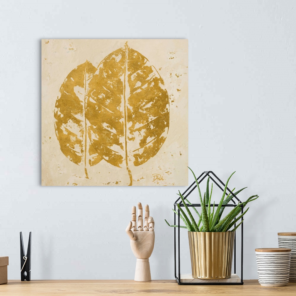 A bohemian room featuring Painting of a golden tropical leaf against a beige background.