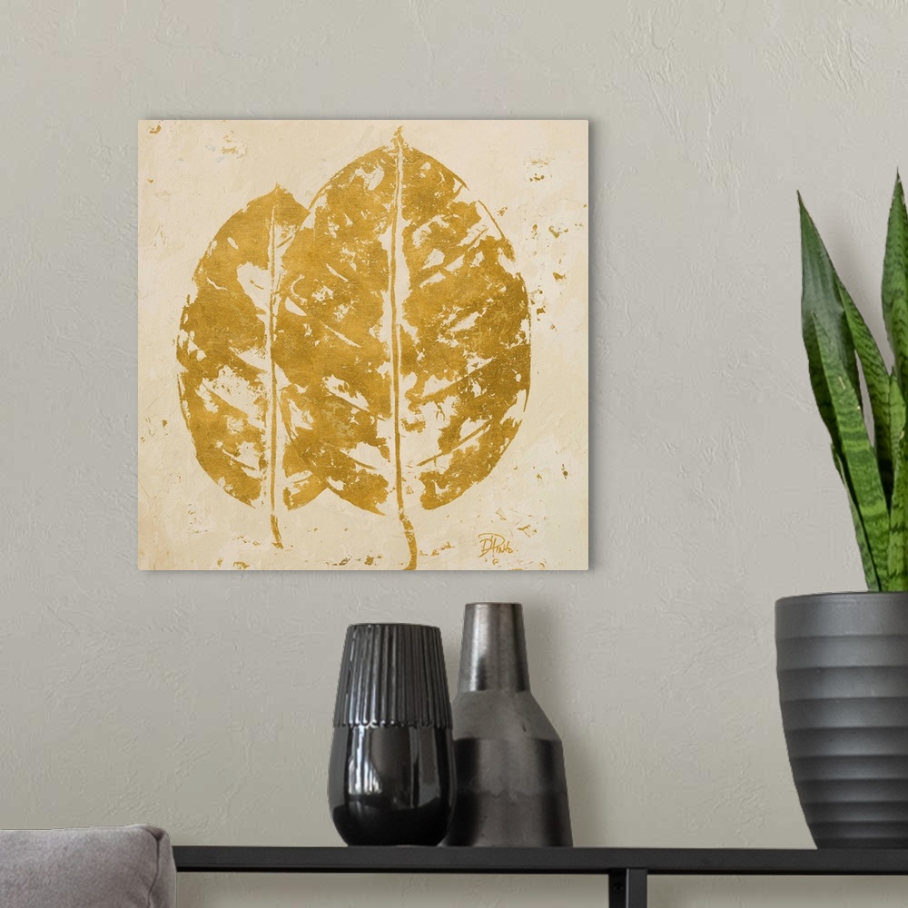 A modern room featuring Painting of a golden tropical leaf against a beige background.