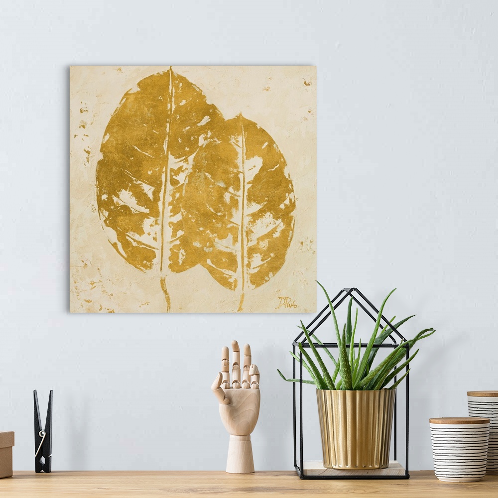 A bohemian room featuring Painting of golden tropical leaves against a beige background.