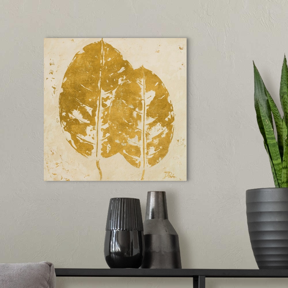 A modern room featuring Painting of golden tropical leaves against a beige background.