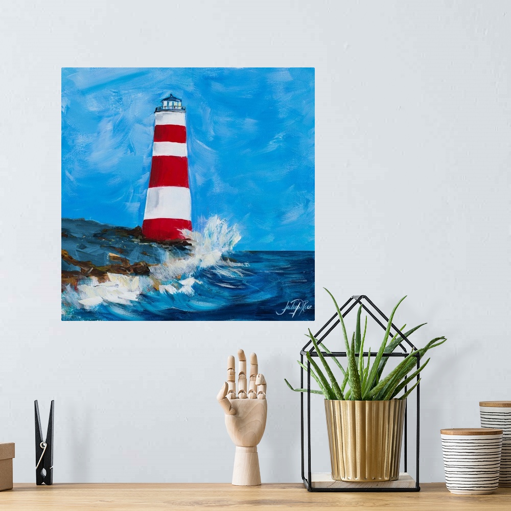 A bohemian room featuring Square painting of a red and white striped lighthouse on the coastline with waves crashing up on it.
