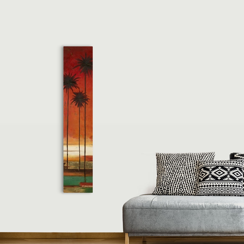 A bohemian room featuring A tall, skinny abstract painting of three palm trees with an orange sunset in the background.