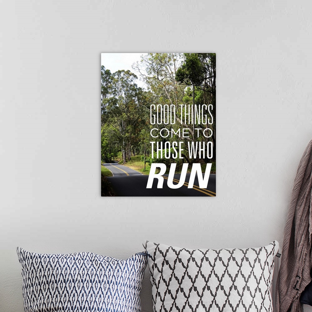 A bohemian room featuring Photo of a road through a forest with the phrase "Good things come to those who run."