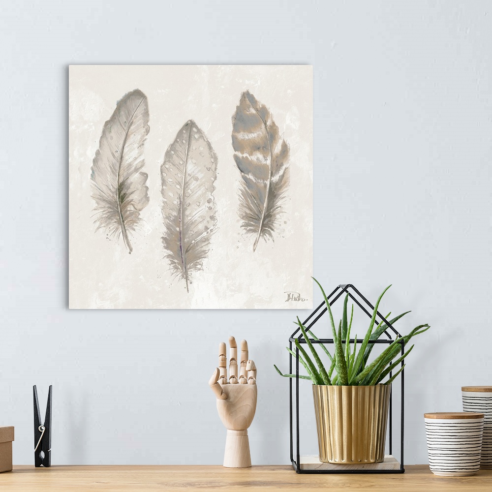 A bohemian room featuring Thee feathers in shades of gray and tan.