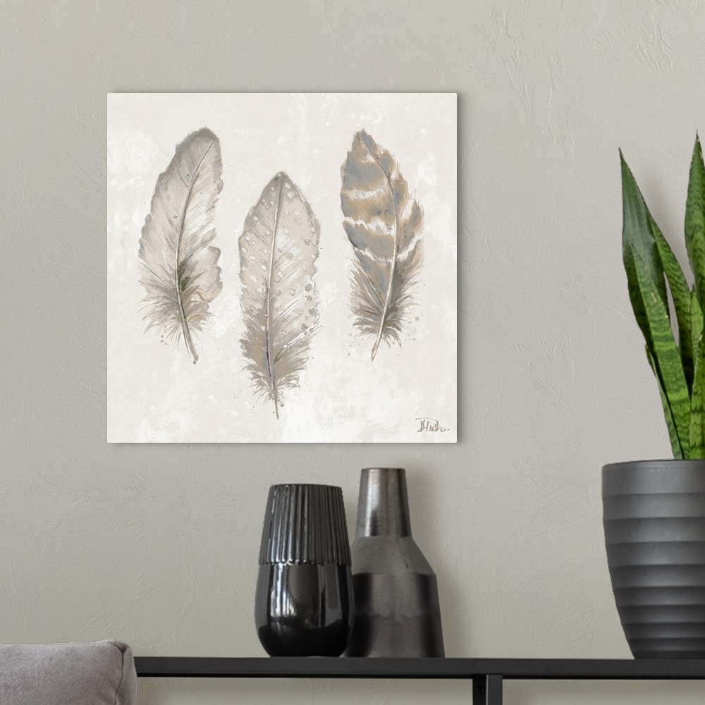 A modern room featuring Thee feathers in shades of gray and tan.