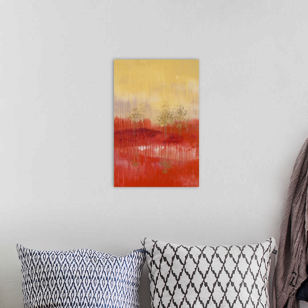 A bohemian room featuring Abstract painting of a red and yellow landscape with golden trees.