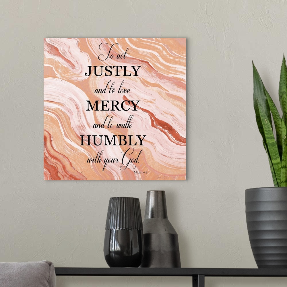 A modern room featuring Square abstract painting of agate in shades of orange and white with the bible verse "To act just...