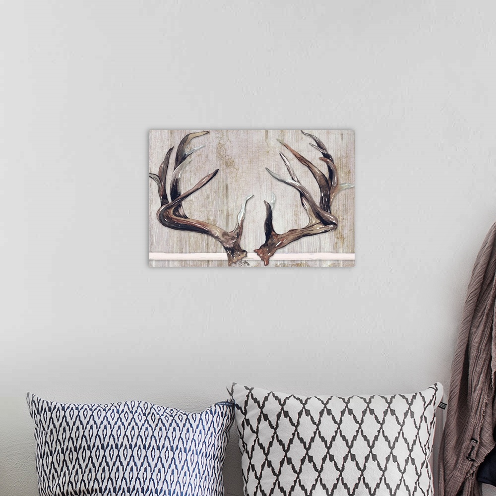 A bohemian room featuring Painting of two sets of deer antlers with a wooden background.