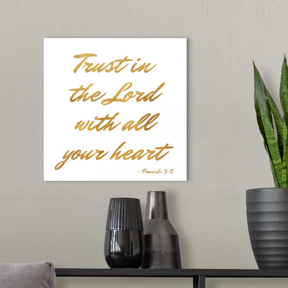 A modern room featuring "Trust in the Lord With All Your Heart" Proverbs 3:5 written in gold on a solid white background.