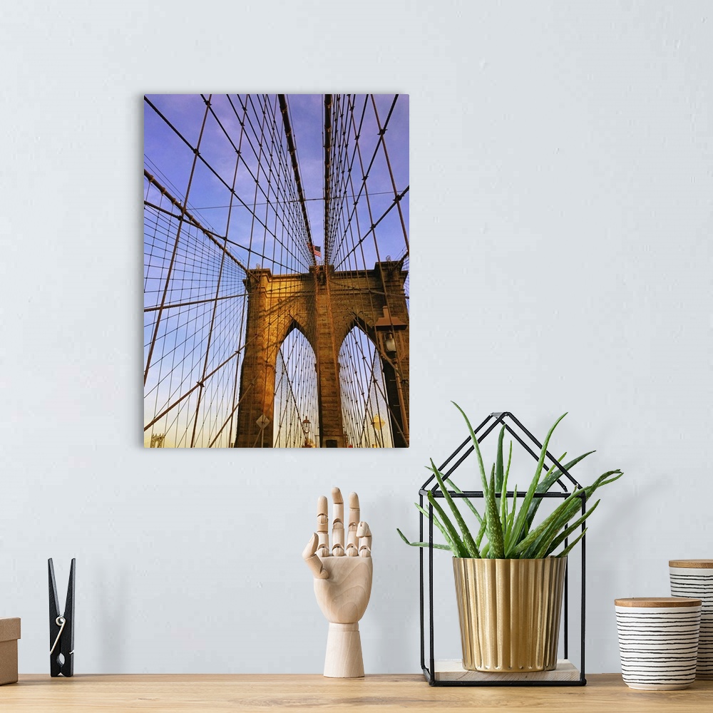 A bohemian room featuring View of the Brooklyn Bridge with criss-crossing suspension cables.