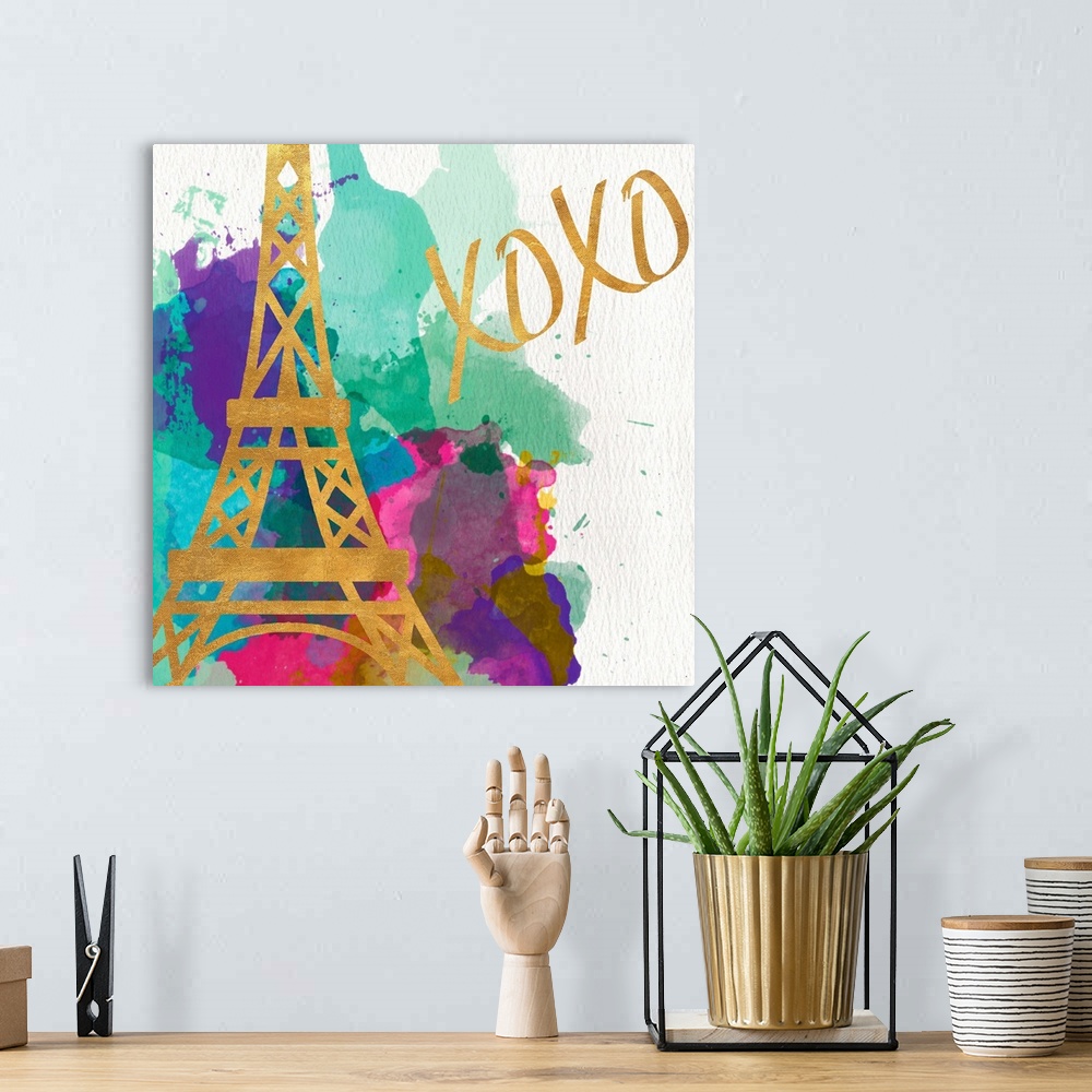 A bohemian room featuring The Eiffel Tower in gold on multicolored watercolor splashes.