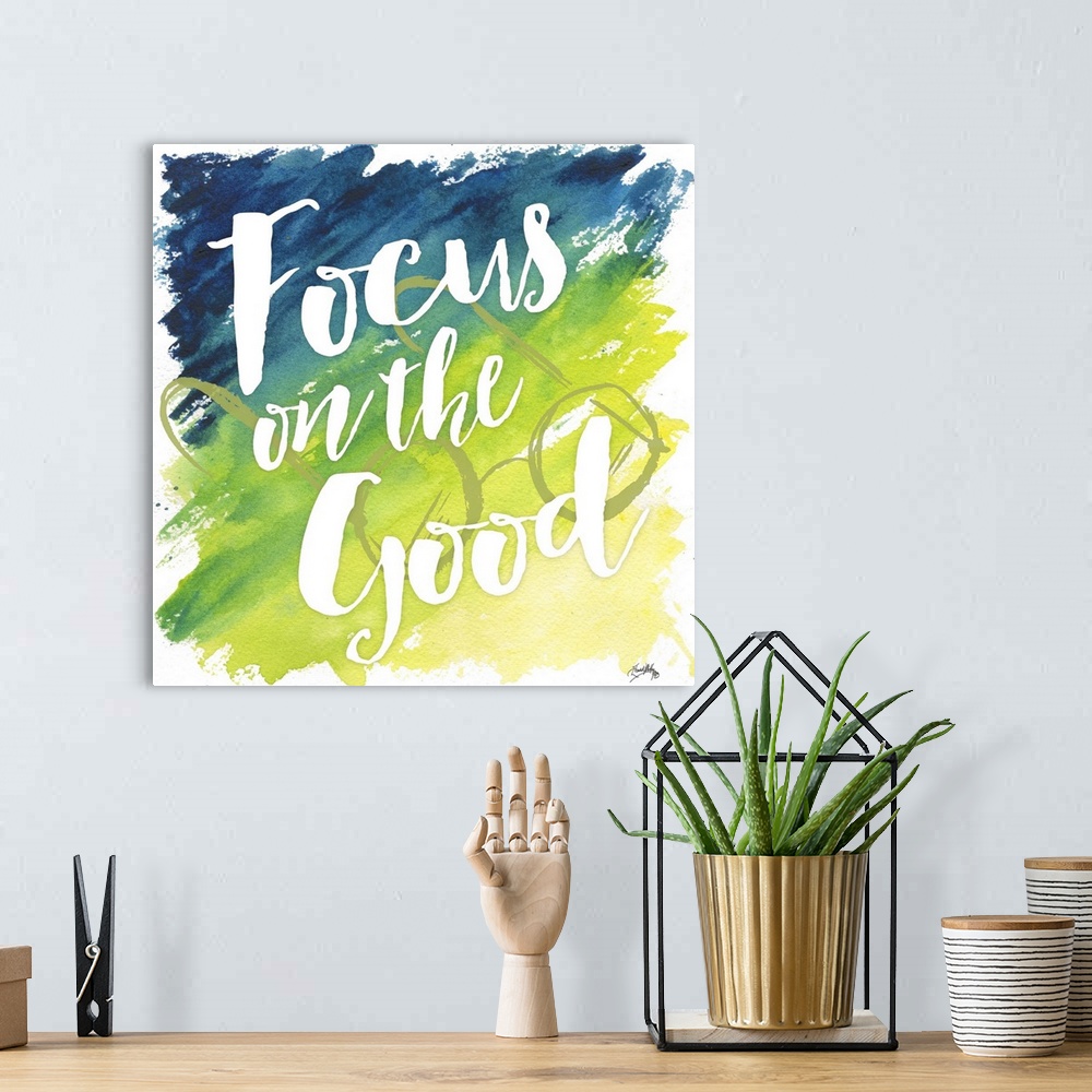 A bohemian room featuring "Focus on the Good" on a blue to yello gradient watercolor background with circular framed eyegla...