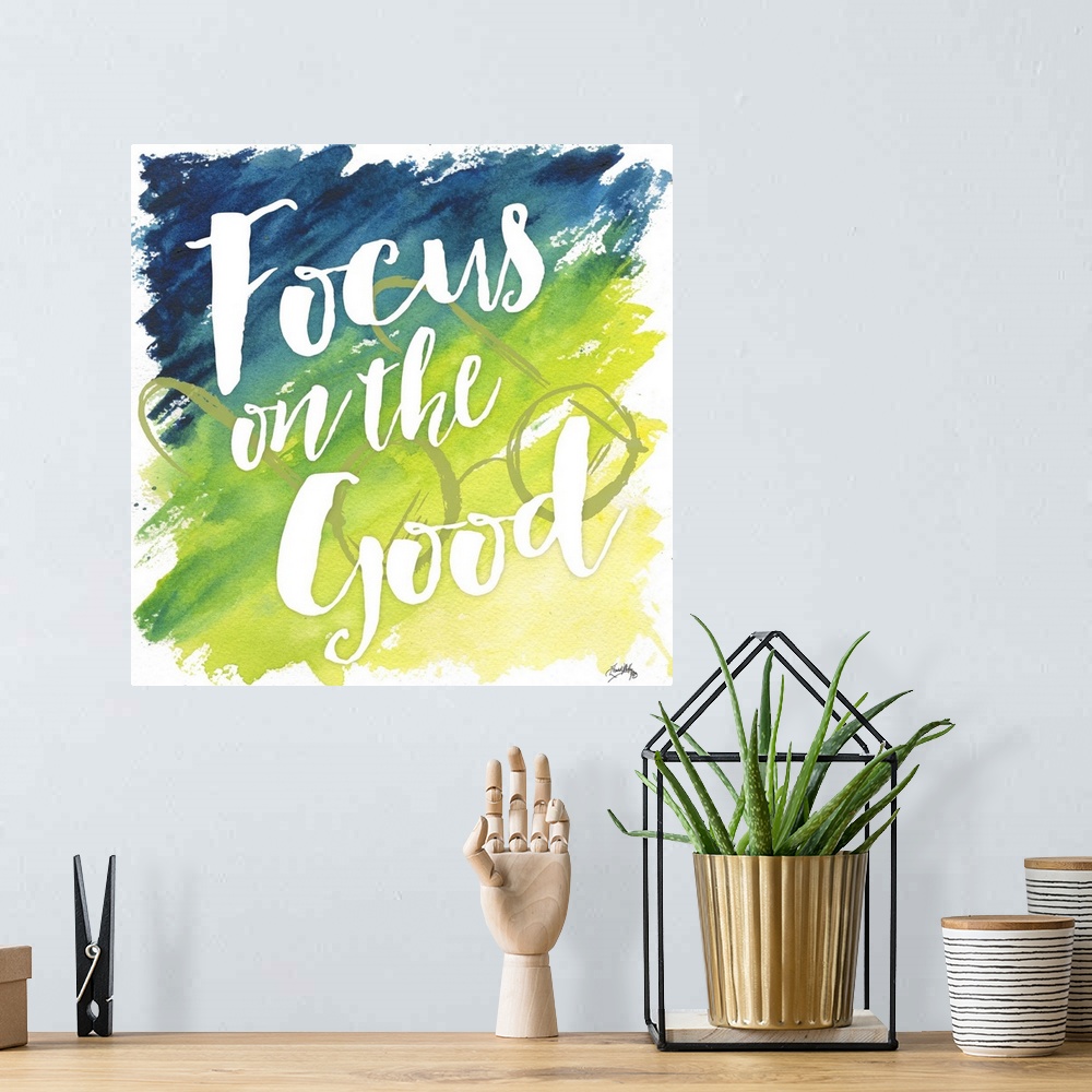 A bohemian room featuring "Focus on the Good" on a blue to yello gradient watercolor background with circular framed eyegla...