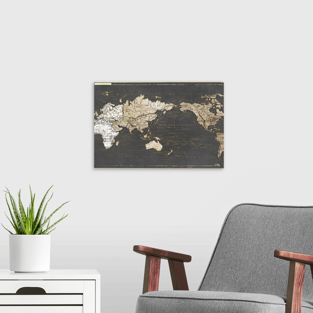 A modern room featuring A gold and gray map of the world written in French.