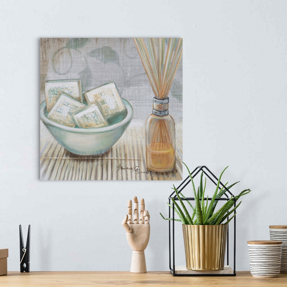 A bohemian room featuring Square, big canvas art of a bowl of square soaps sitting on a bamboo mat, next to that is a clear...