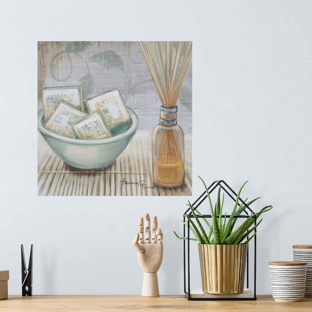A bohemian room featuring Square, big canvas art of a bowl of square soaps sitting on a bamboo mat, next to that is a clear...