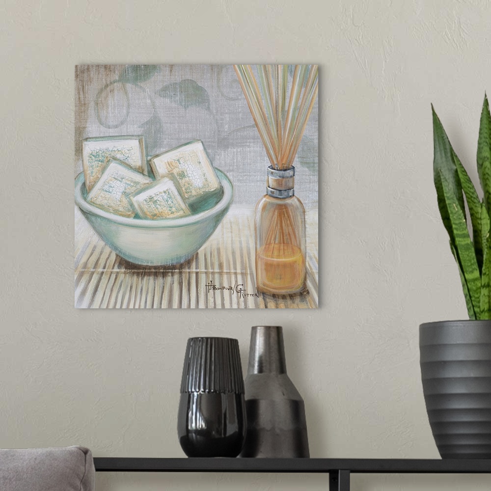 A modern room featuring Square, big canvas art of a bowl of square soaps sitting on a bamboo mat, next to that is a clear...
