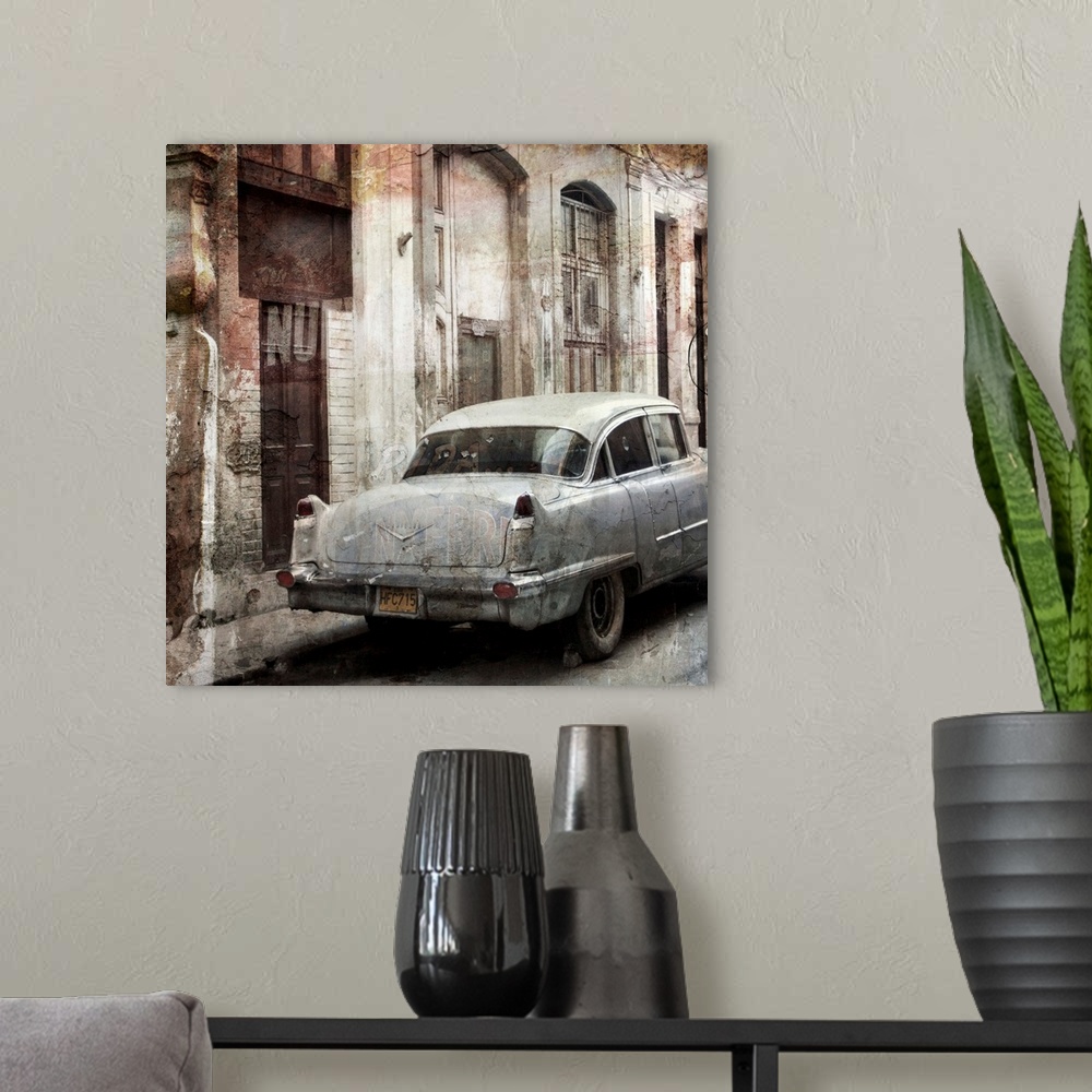 A modern room featuring Photograph of a vintage car parked on a street, next to decayed looking buildings.