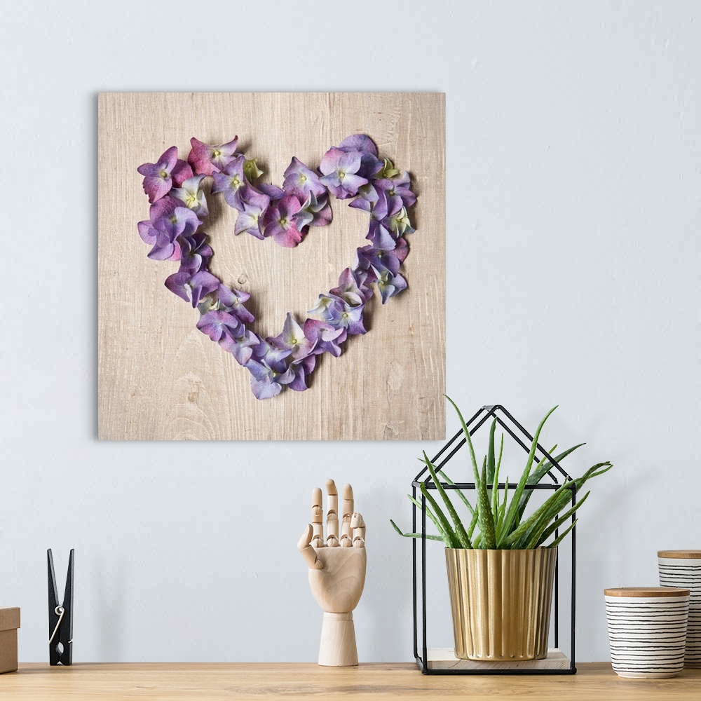 A bohemian room featuring Photograph of purple flowers arranged in the shape of a heart.