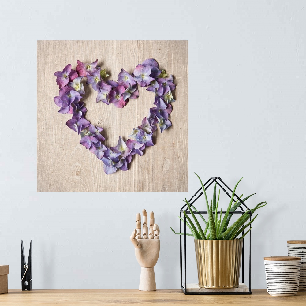 A bohemian room featuring Photograph of purple flowers arranged in the shape of a heart.