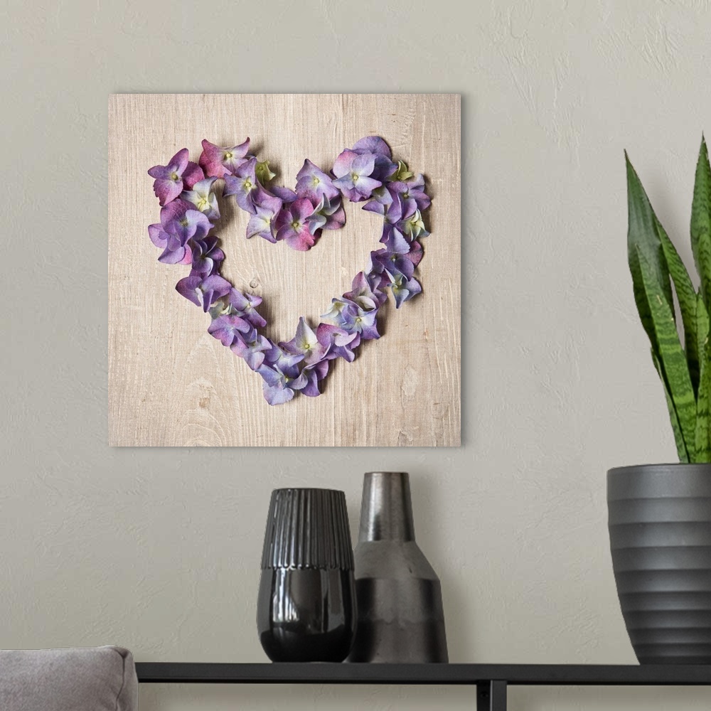 A modern room featuring Photograph of purple flowers arranged in the shape of a heart.