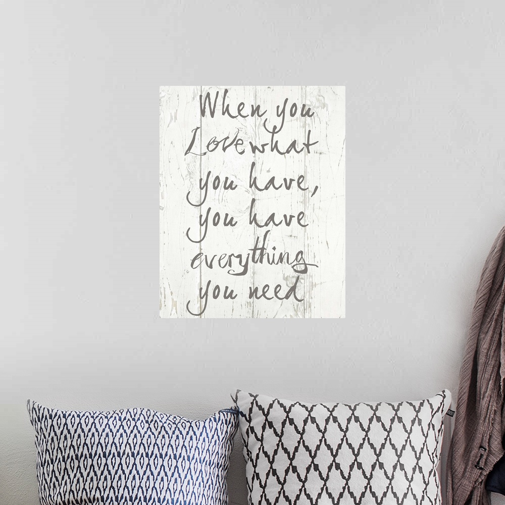 A bohemian room featuring Contemporary artwork of an inspirational quote on a textured wood plank background.