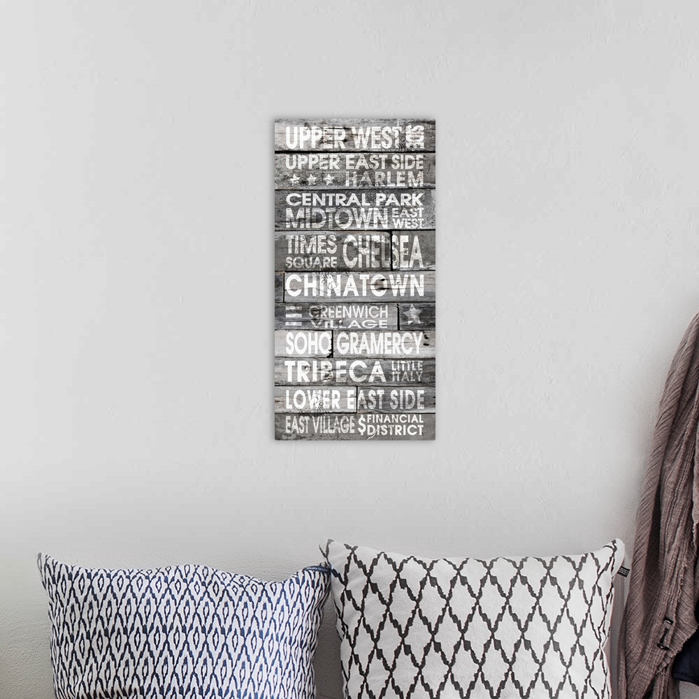 A bohemian room featuring Contemporary artwork of locations in a stressed stencil style on a wood plank looking background.