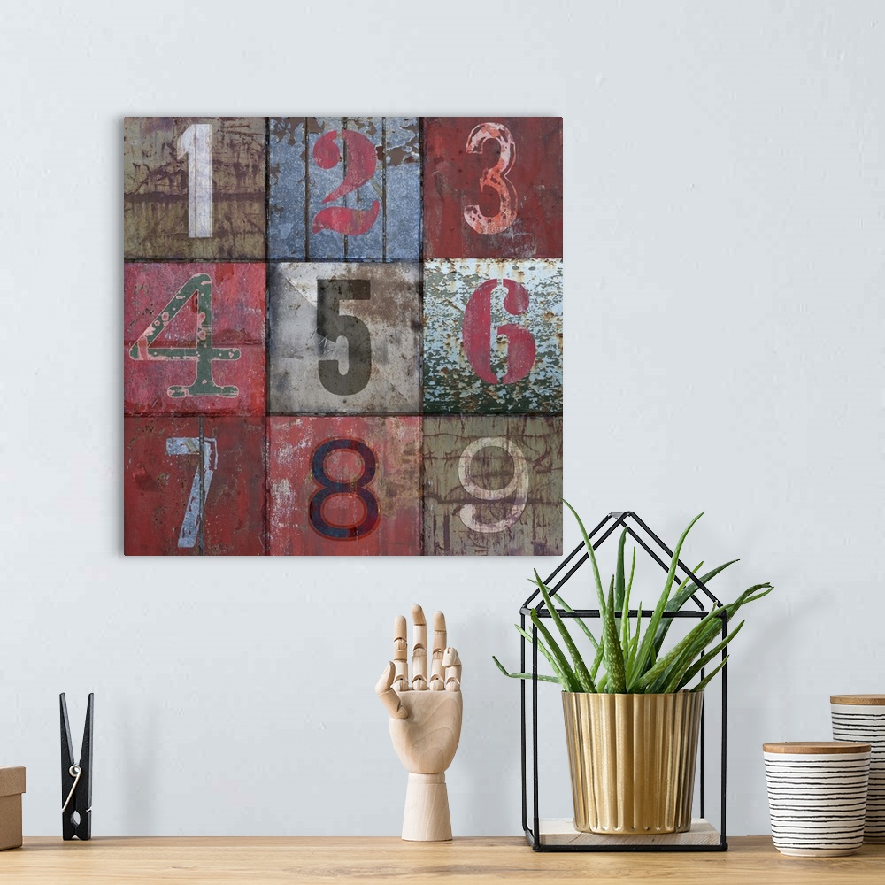A bohemian room featuring Contemporary artwork of numbers painted in different styles on a weathered surface.