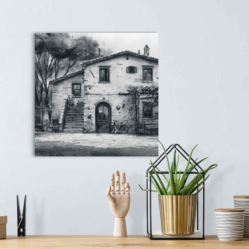 A bohemian room featuring Monochrome painting of a rustic Tuscan villa structure.