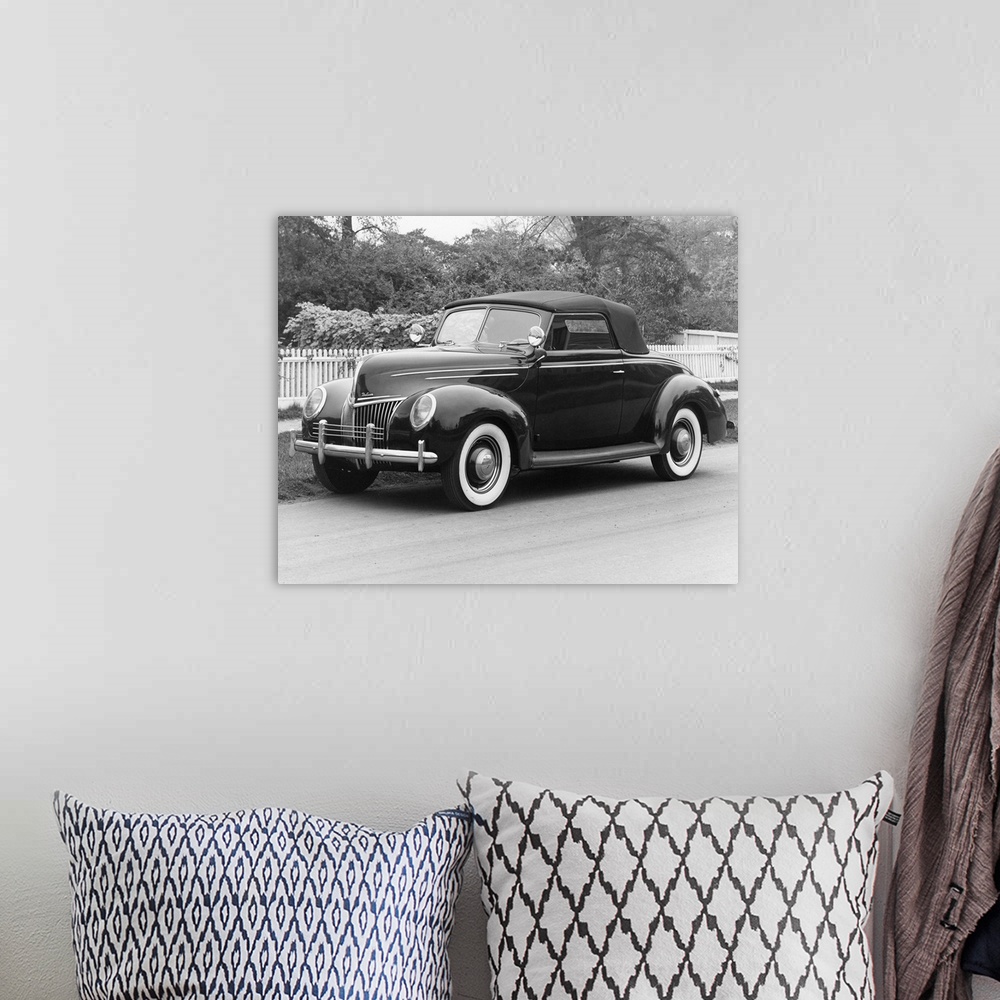 A bohemian room featuring A 1939 Ford Deluxe Coupe. Photograph.