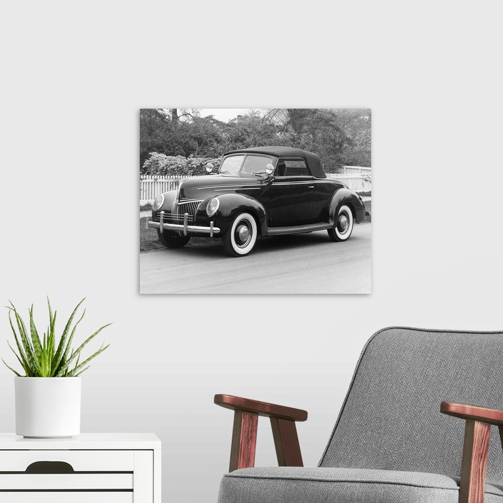 A modern room featuring A 1939 Ford Deluxe Coupe. Photograph.
